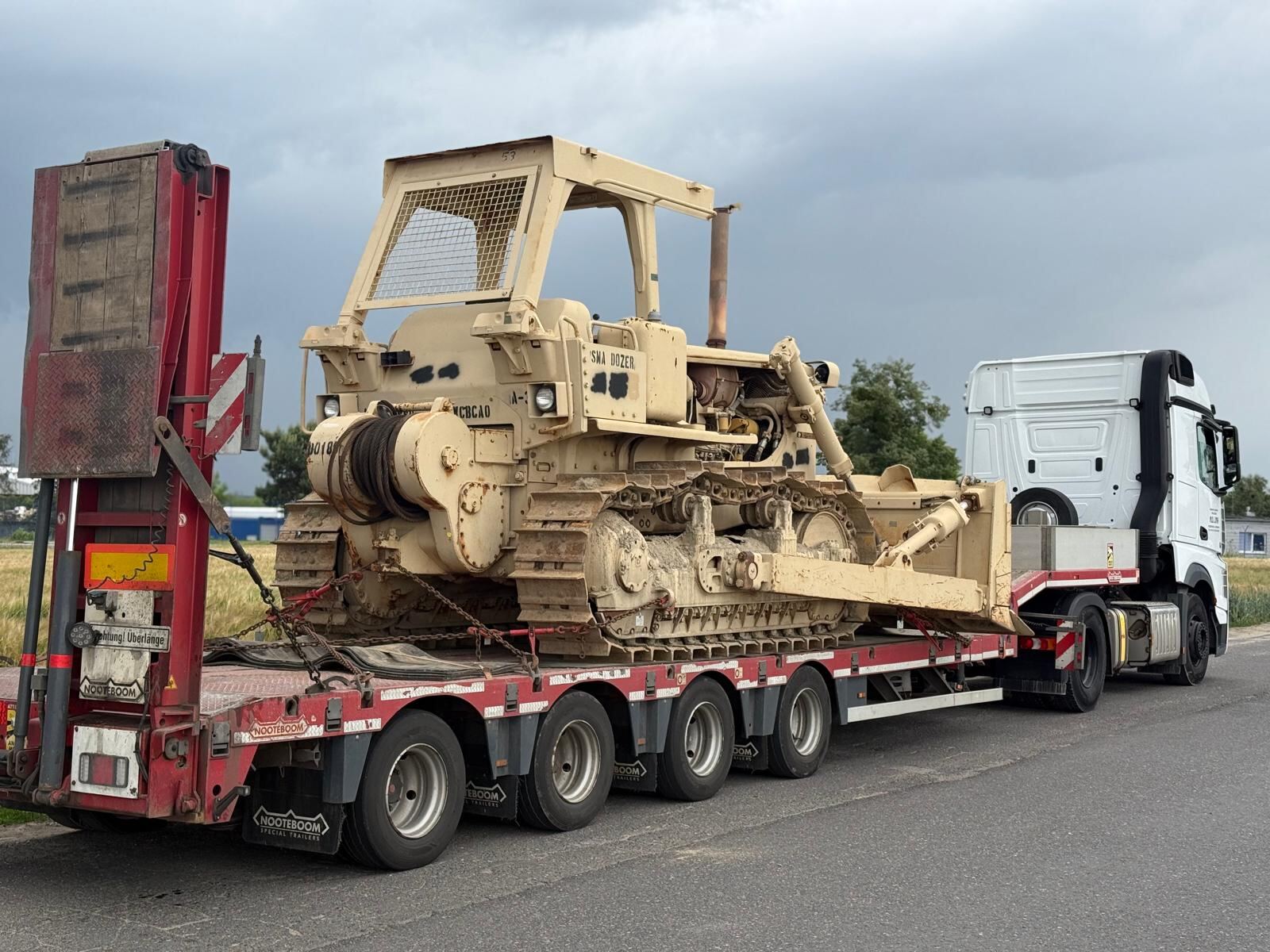 Armoured bulldozer secured on a lowloader trailer